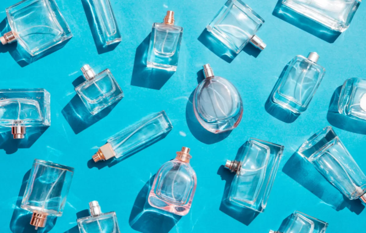Empty Perfume Bottles on Blue Background