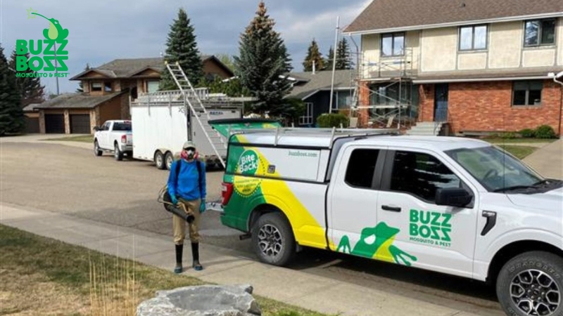 Buzz Boss worker in front of a truck with spraying equipment